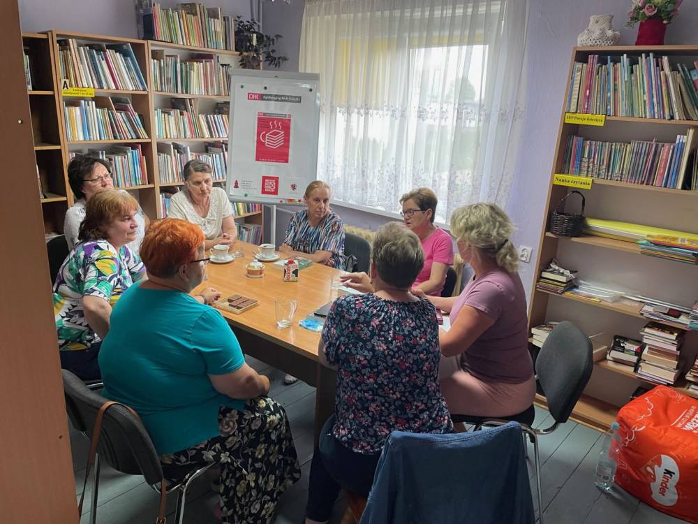 Zdjęcie przedstawia uczestników DKK dla dorosłych podczas spotkania w bibliotece